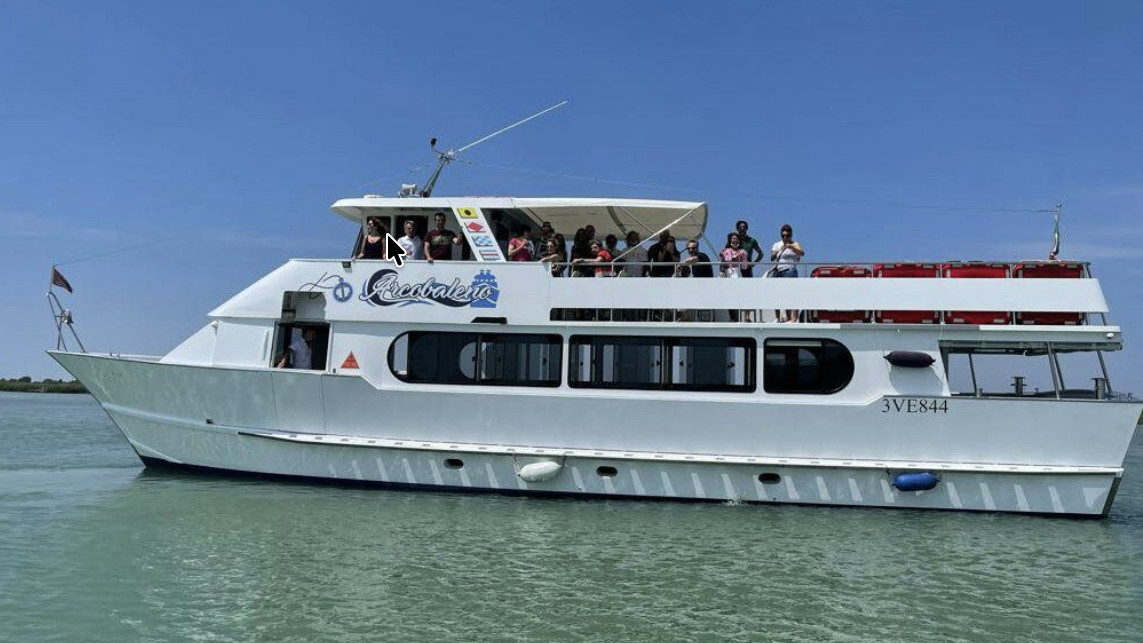 Tourist boat "Arcobaleno" cruising in the Caorle Lagoon, Italy.