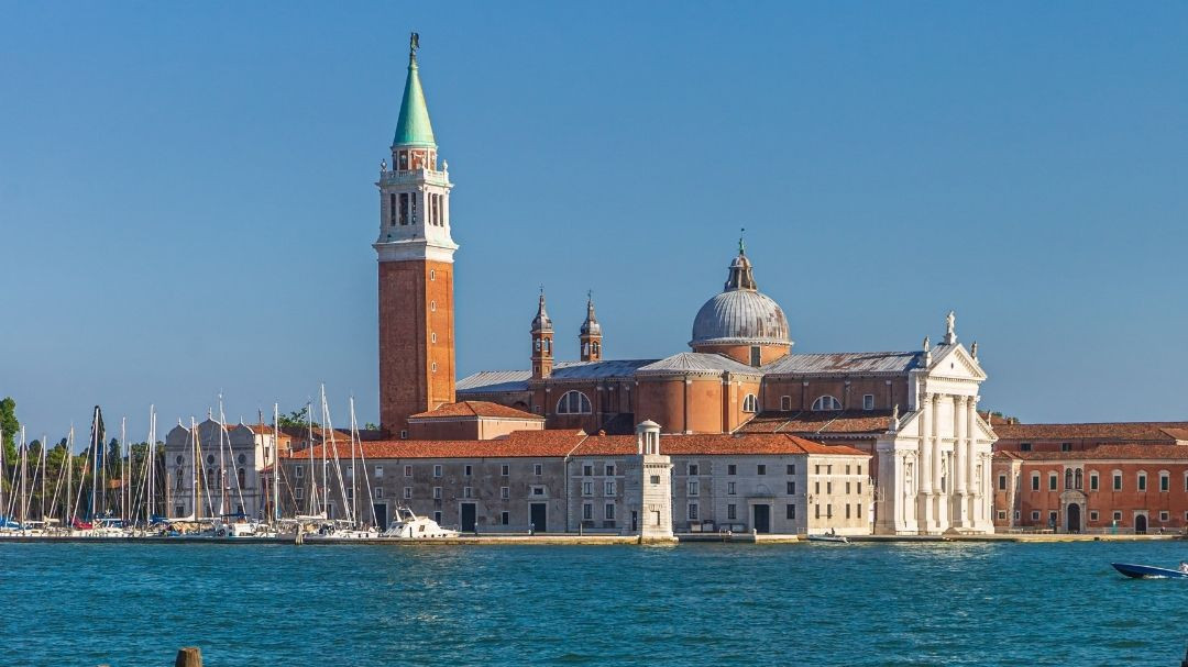 San Giorgio Maggiore church and bell tower viewed from the water across the Venetian Lagoon in Venice, Italy.