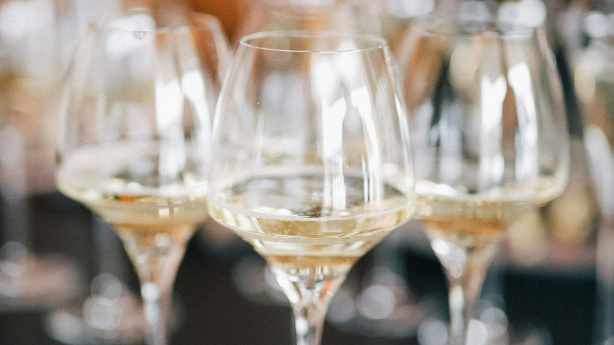 Close-up of sparkling white wine in crystal glasses, highlighting the clarity and bubbles during a premium wine tasting event