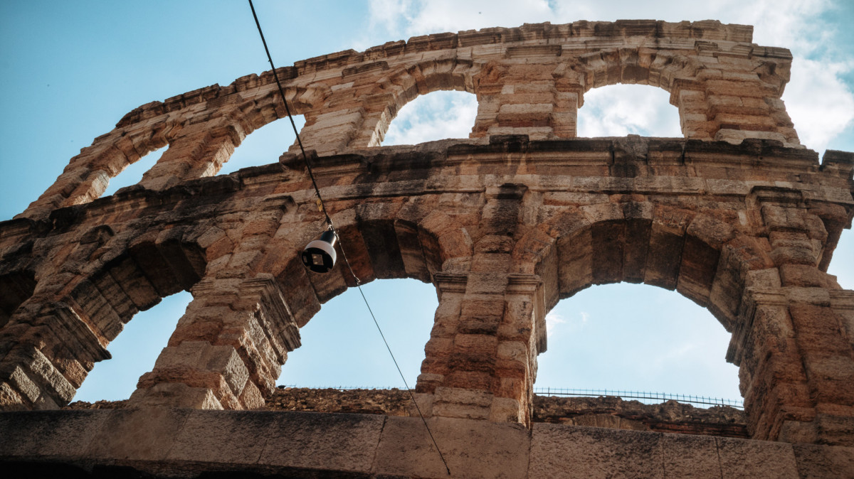 Arena di Verona arches with blue sky in the background