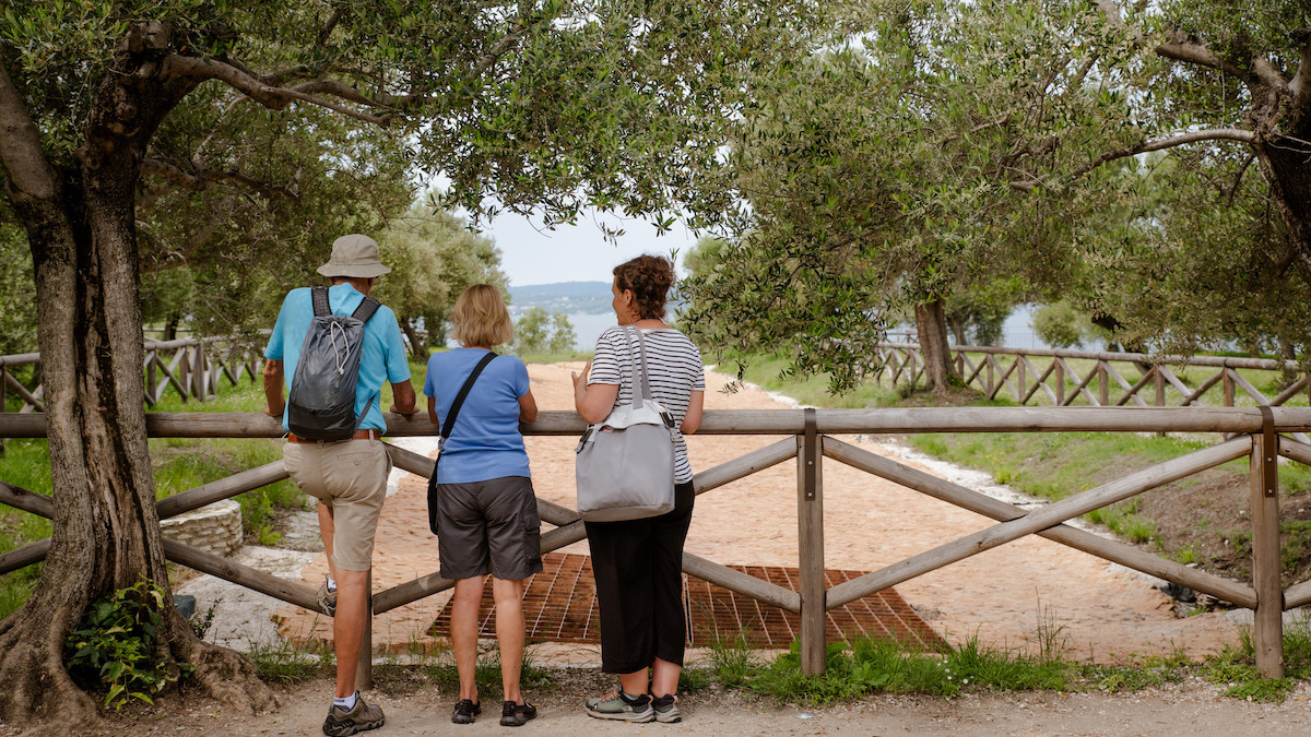 Tourists observing romans ruin in the Grotte di Catullo archeological site