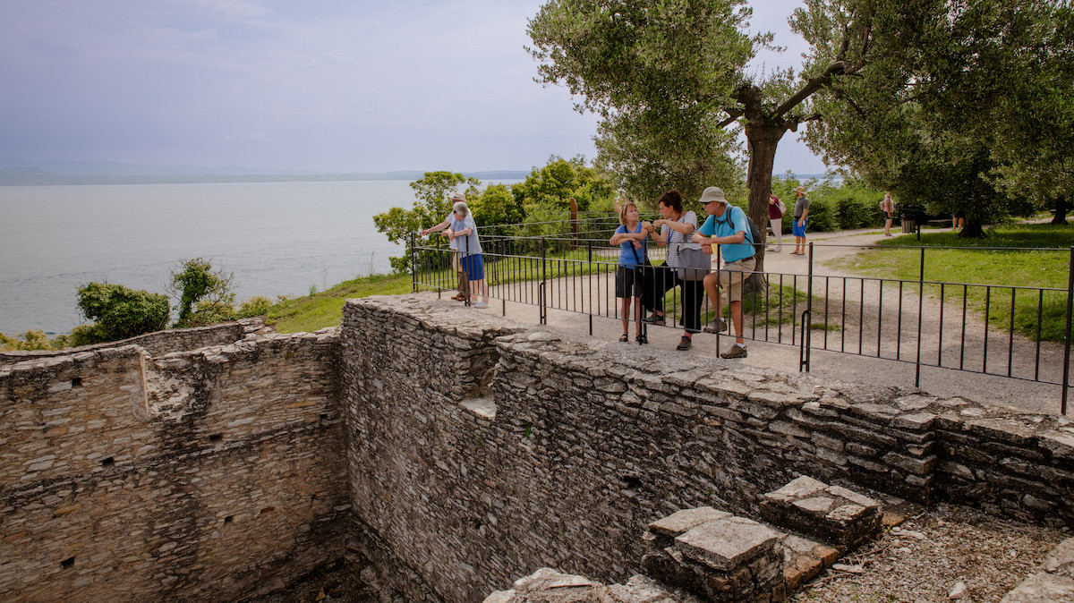 Tourists exploring a key section of the Roman villa, enjoying breathtaking views of the lake.