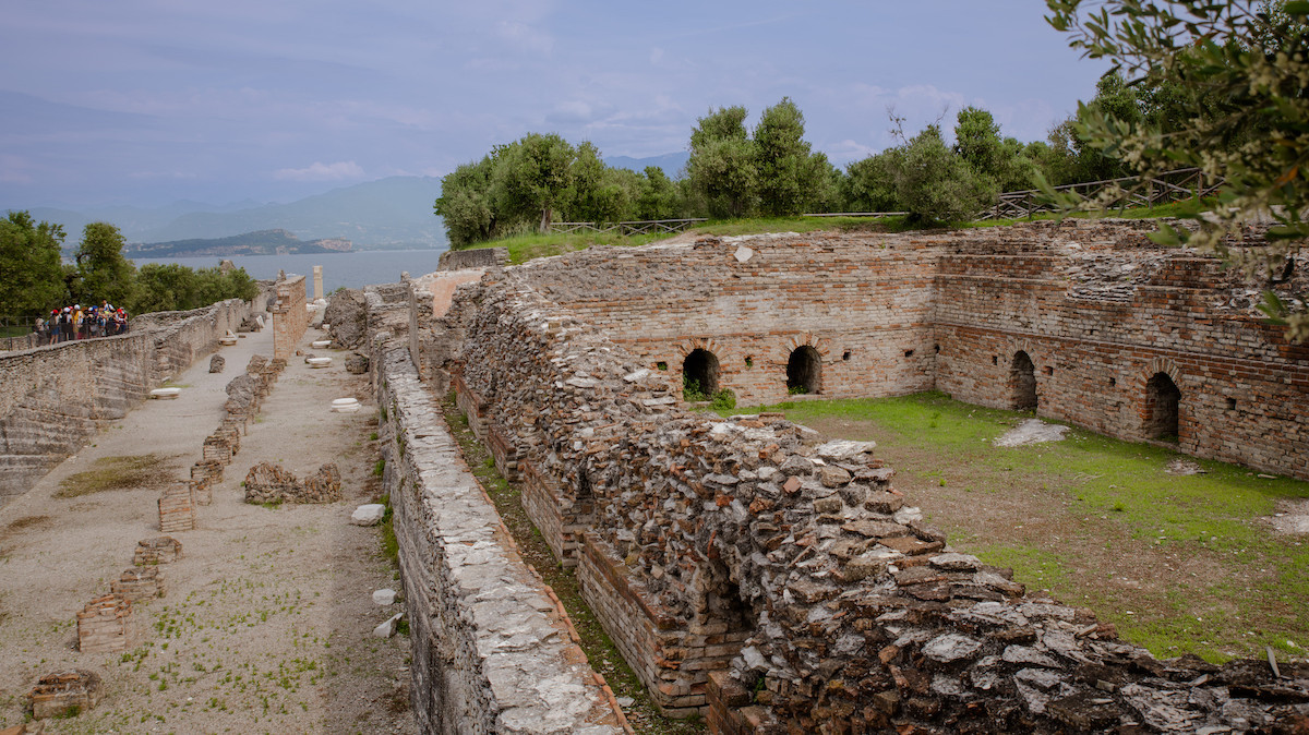 Archaeological site of a Roman villa, set against lush greenery with stunning lake views.