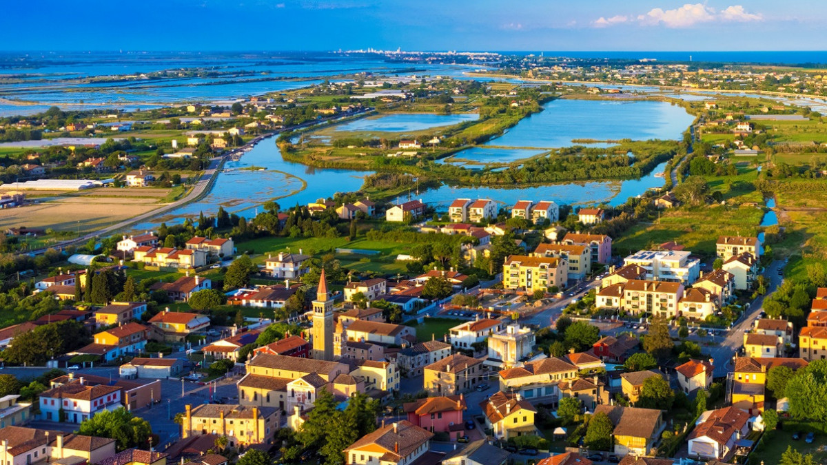 Aerial panoramic view of Saccagnana village in Cavallino-Treporti, showing traditional houses and the stunning Venetian Lagoon landscape