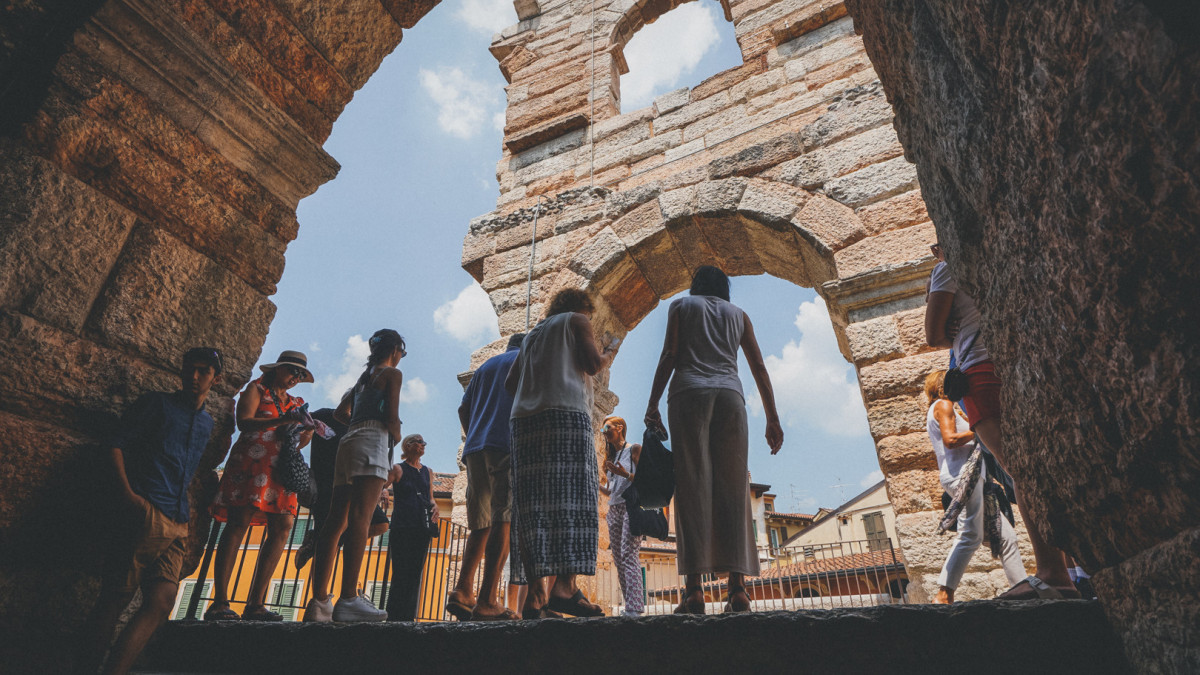 Tourists gathered around the guide, listening attentively to fascinating insights about the Arena di Verona and its rich history.
