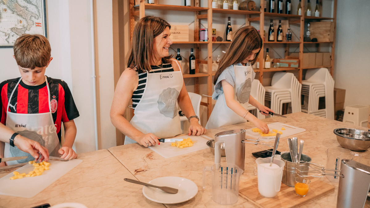 Children making italian gelato during the cooking class in verona