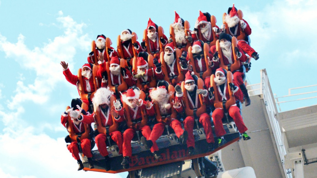 Dozens of people dressed as Santa Claus experiencing the vertical drop on Oblivion - The Black Hole dive coaster at Gardaland Park, Italy.