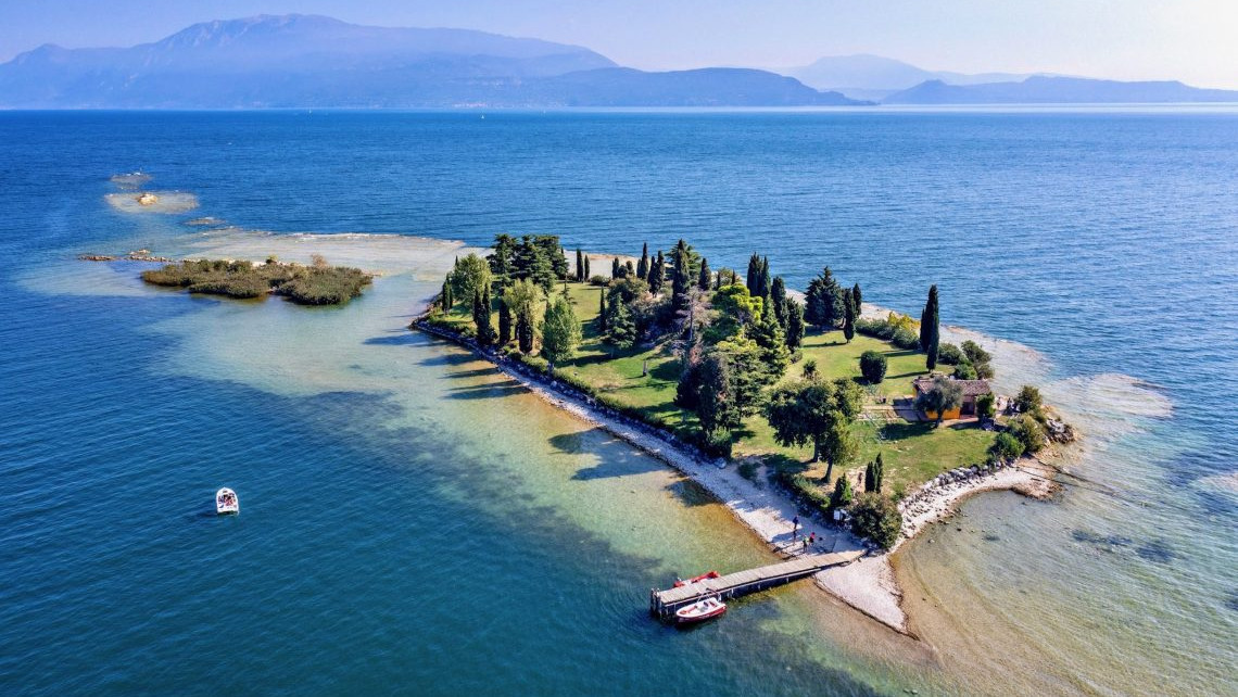 Scenic landscape of the picturesque Isola di San Biagio (Rabbit Island) on Lake Garda, a popular destination for boat excursions.