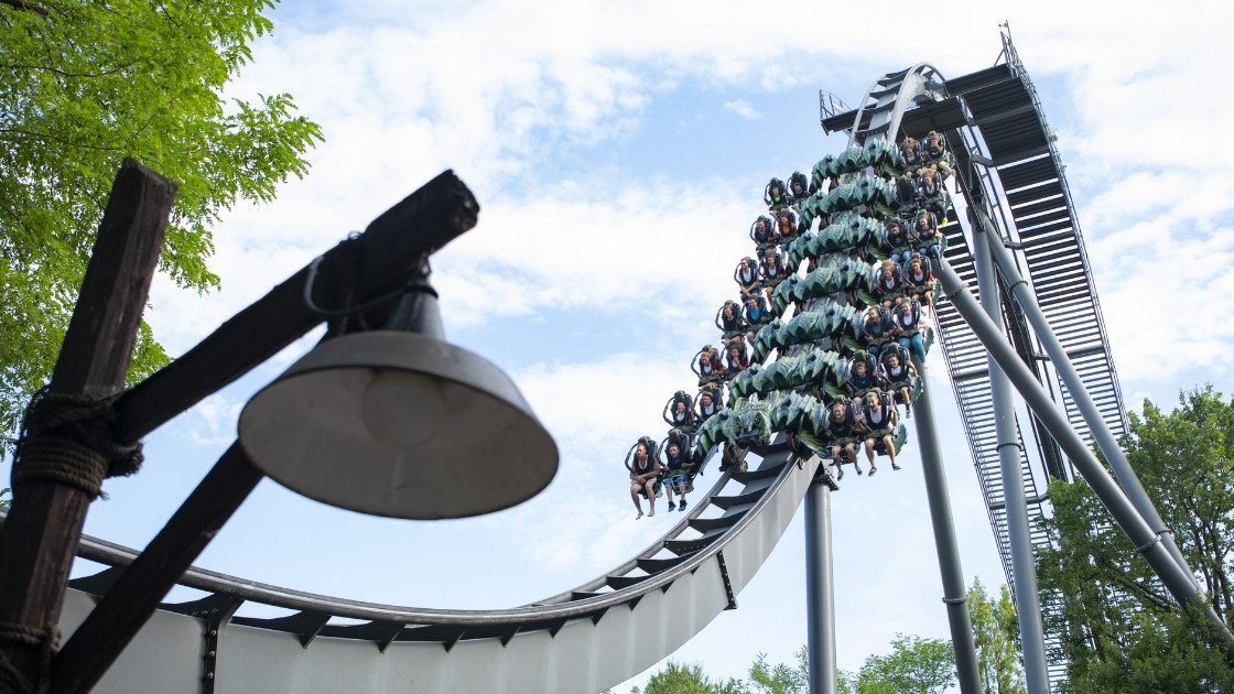Thrilling Raptor rollercoaster with riders descending a steep drop at Gardaland