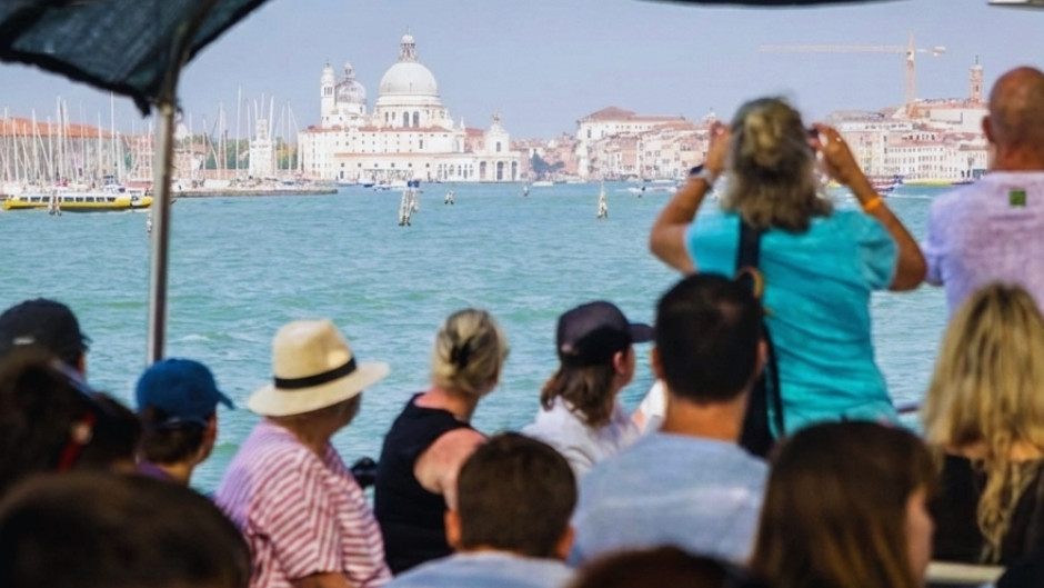 View of the Basilica di Santa Maria della Salute from a passenger boat at the entrance of the Grand Canal in Venice, Italy.