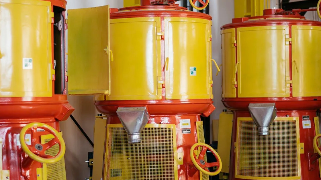 Traditional yellow and orange rice whitening machines at Azienda Agricola La Fagiana, showcasing the authentic artisanal processing of Italian rice.